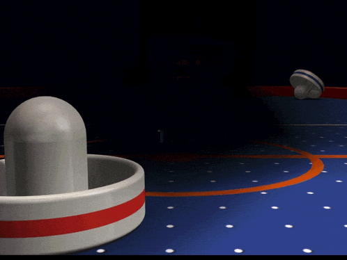a game of air hockey is being played on a table