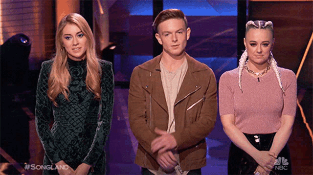 a group of three people standing next to each other with the words songland on the bottom