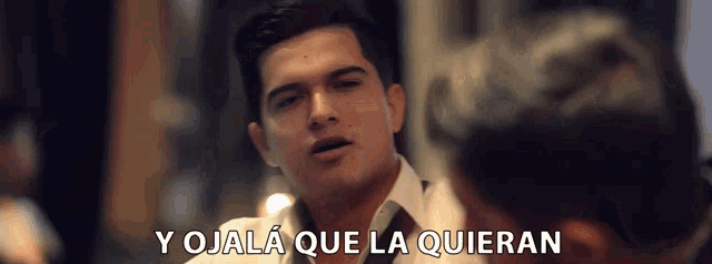 a man says y ojalá que la quieran while looking at another man