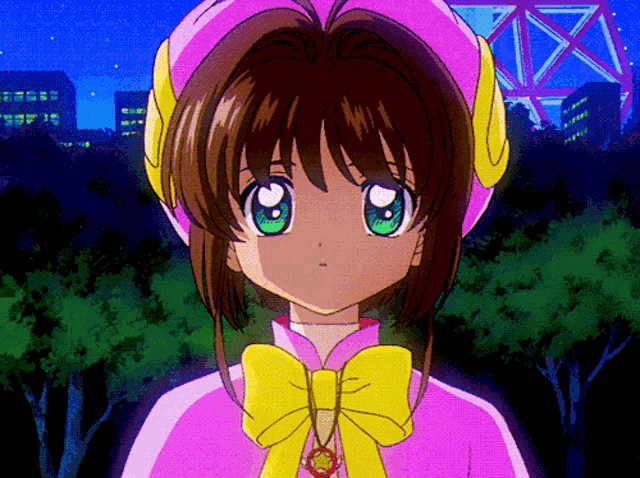 a girl with green eyes is wearing a pink and yellow outfit with a yellow bow