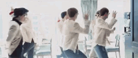 a group of young men are dancing in a room .