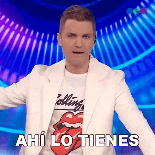 a man wearing a rolling stones t-shirt and a white jacket says ahi lo tienes