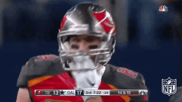 a football player wearing a helmet with the nfl logo behind him