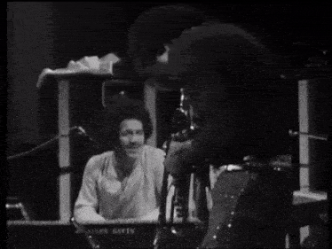 a man playing a keyboard in a black and white photo