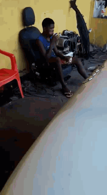 a man is sitting in a chair playing a game