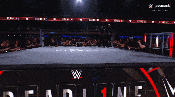 a wrestling ring with a peacock logo on the bottom