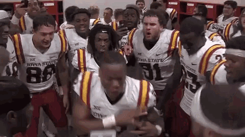 a group of football players wearing iowa state jerseys