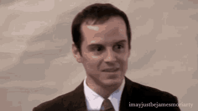 a man in a suit and tie is making a face .