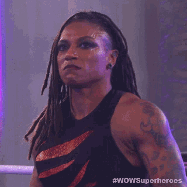 a woman with dreadlocks is wearing a black tank top that says wowsuperheroes on it