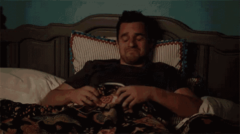 a man is sleeping in a bed with his eyes closed .