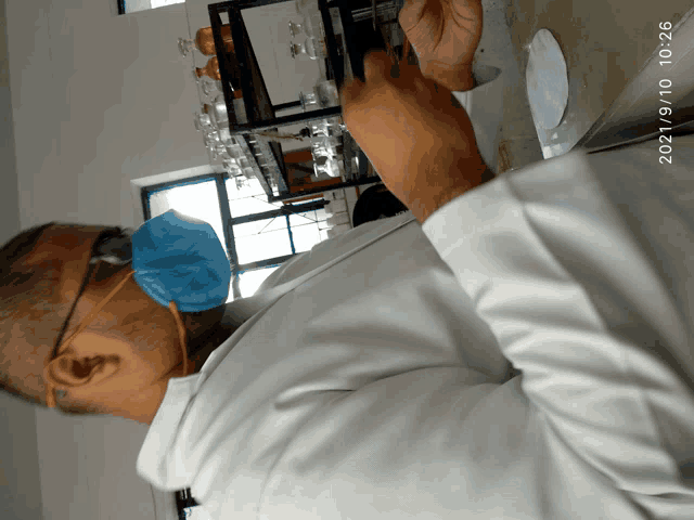 a man wearing a mask and glasses is working in a laboratory