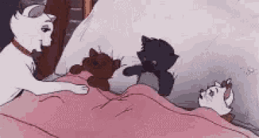 a group of cats are laying on a bed with a pink blanket .