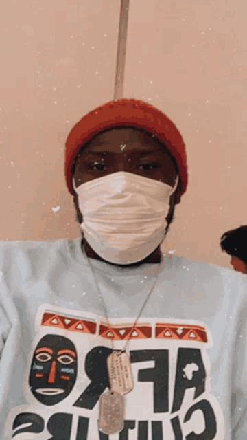 a man wearing a mask and a blue shirt that says ' osama ' on it