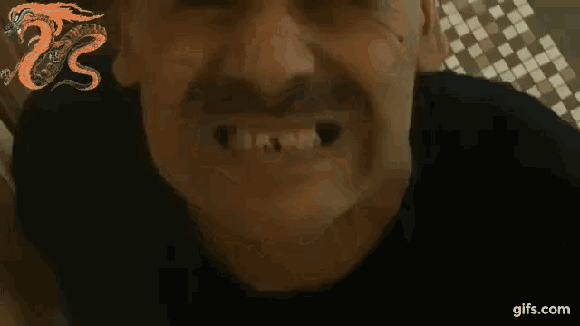 a close up of a man 's face with the website gifs.com in the corner
