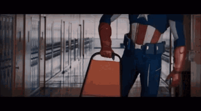 a man in a captain america costume is holding a chair