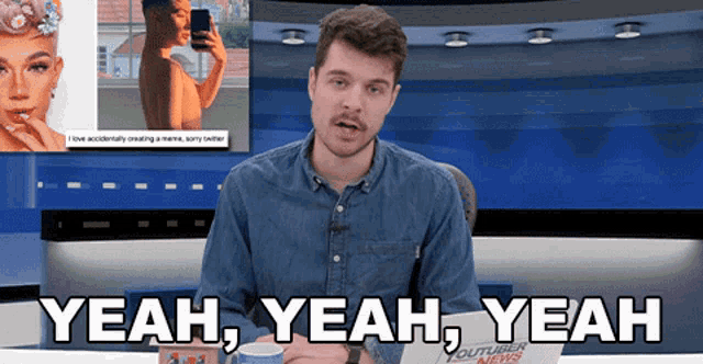 a man sitting in front of a screen that says " yeah yeah yeah " on it