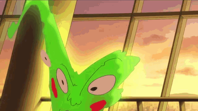 a green cartoon character with red eyes is standing in front of a large window