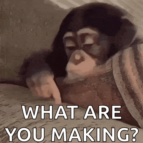 a chimpanzee is pointing at something with the words `` what are you making '' written below it .