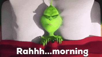 a cartoon grinch is laying in a bed with the words " rahh... morning " written below him