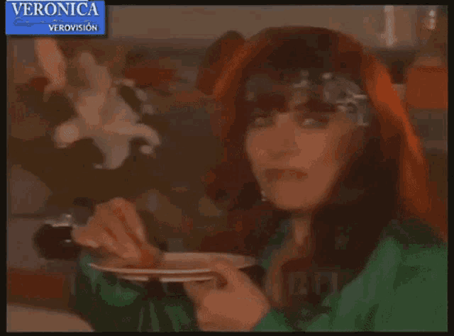 a woman in a green shirt is holding a cup with the name alicia montoya on it