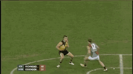 a soccer player is being tackled by another player and the word no is above them