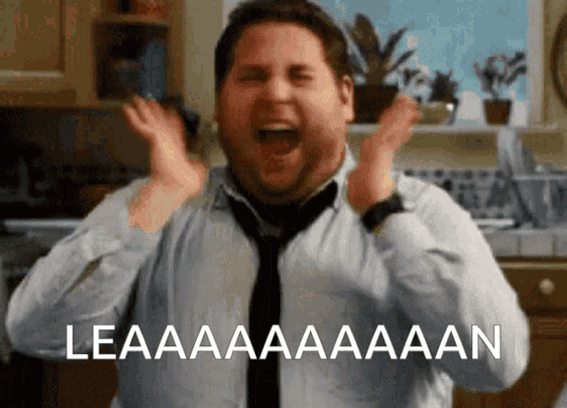a man in a tie is screaming in a kitchen with the words leaaaaaaaan written below him