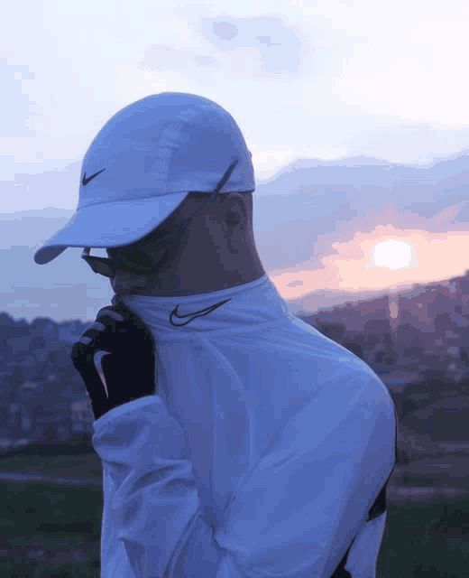 a man wearing a white nike hat and a white nike shirt