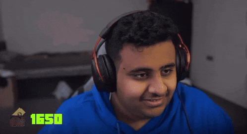 a man wearing headphones and a blue shirt with the number 1650 on the bottom