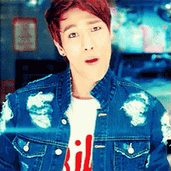 a young man wearing a denim jacket and a red t-shirt with the letter ii on it