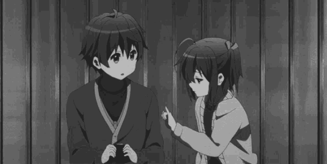 a boy and a girl are standing next to each other and the girl is pointing at the boy