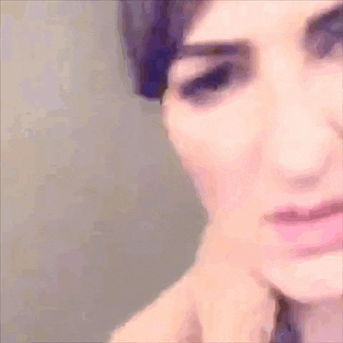 a close up of a woman 's face with a serious look on her face