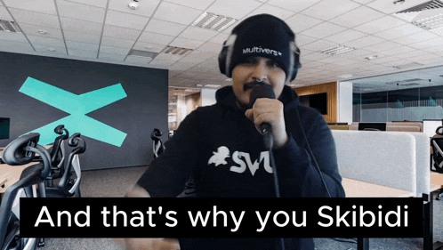 a man singing into a microphone with the words and that 's why you skibidi