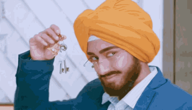 a man in a turban is holding a bunch of keys in his hand
