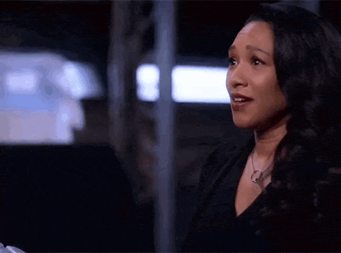 a woman in a black shirt and necklace is talking to another woman .