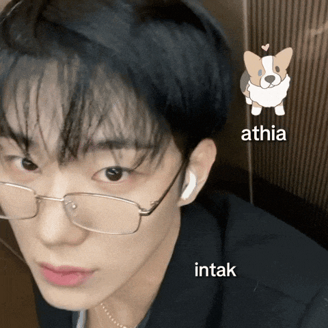 a close up of a person wearing glasses with athia intak and a dog icon