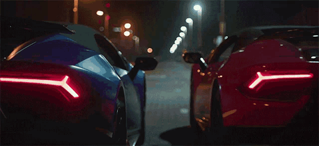 a blue car with a license plate that says cc chk is parked next to a red car