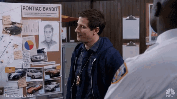 a man standing in front of a bulletin board that says pontiac bandit on it