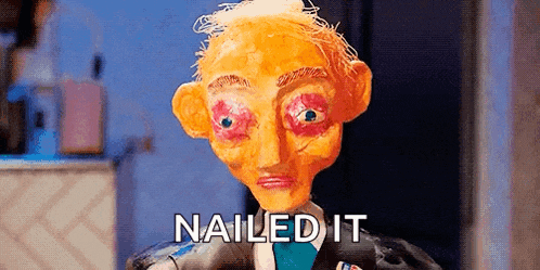 a close up of a puppet with the words `` nailed it '' written on it .