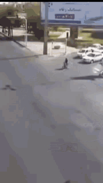 a person is riding a bike down a street while a car is driving by