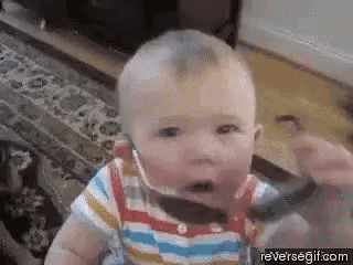 a baby wearing headphones and a bow tie is sitting on a carpet in a living room .