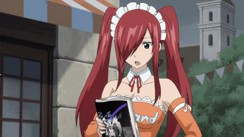 a girl with red hair is holding a magazine that says " and " on it