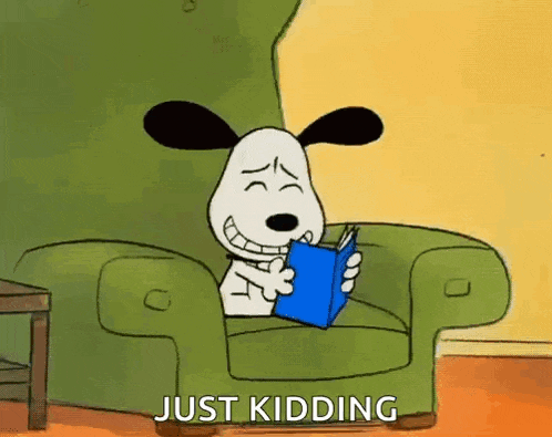 a cartoon dog is sitting in a chair reading a book and saying just kidding .