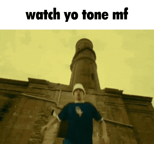 a man standing in front of a building with the words watch yo tone mf written on the bottom