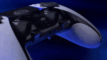 a playstation controller is next to a remote that says 1 on it
