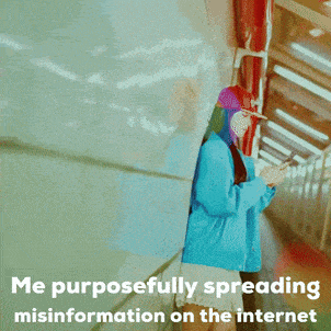 a woman in a blue jacket is looking at her phone with the caption " me purposefully spreading misinformation on the internet " below her