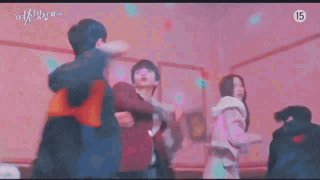 a man and a woman are fighting in a room in a korean drama .