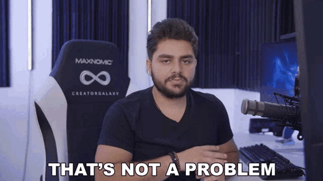a man sitting in front of a computer with the words that 's not a problem behind him