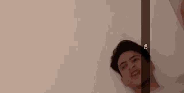 a man is laying in a bathtub and making a funny face with his mouth open .
