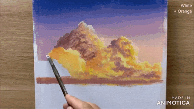 a person is painting a cloudy sky with white and orange paint