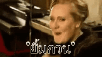 a woman is making a funny face in front of a microphone in a room .